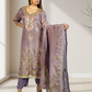 Woman wearing a traditional embroidered outfit with a matching dupatta in a well-lit room.
