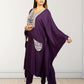 Woman wearing a purple outfit with white embroidery against a white background