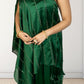 Green one-shoulder dress with ruffled details on a plain background