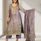 Woman wearing a purple embroidered outfit with a matching dupatta, standing indoors.