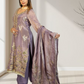 Woman wearing a traditional outfit with a purple dupatta in a well-lit room.