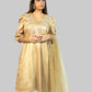 Woman wearing a gold traditional outfit with a plain background