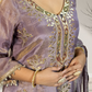 Purple embroidered garment with gold detailing worn by a person.