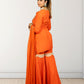 Woman wearing an orange traditional outfit with a white background