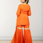 Woman wearing an orange traditional outfit with lace details on a white background