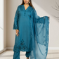 Woman wearing a blue embroidered outfit with a matching dupatta indoors.