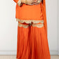 Orange traditional outfit with gold embroidery on a white background
