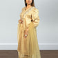 Woman wearing a gold traditional outfit with a plain background