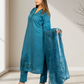 Woman wearing a blue embroidered outfit with a matching dupatta in a well-lit room.