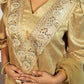 Gold embroidered traditional outfit with a plain background