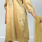 Gold traditional outfit with intricate designs on a plain background