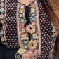 Person wearing a intricately designed garment with colorful patterns and embroidery.