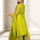 Woman wearing a green traditional outfit with a white background