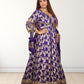 Woman wearing a purple and gold traditional outfit on a white background