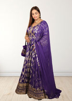 Woman wearing a purple traditional outfit with gold patterns on a white background
