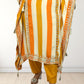 Person wearing a traditional outfit with orange and yellow stripes on a white background