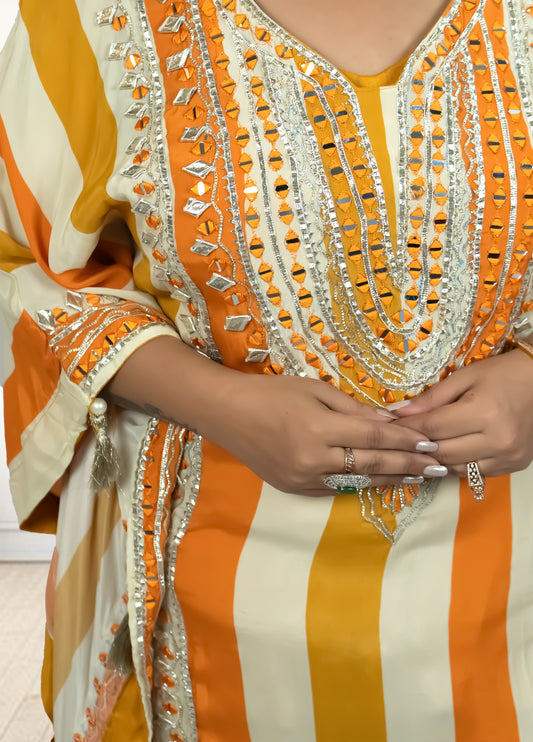 Orange and white striped garment with intricate detailing