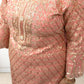 Pink and gold embroidered dress with a plain background
