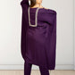 Person wearing a purple outfit with intricate detailing on a white background
