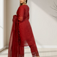 Woman wearing a red outfit with lace details in a minimal indoor setting