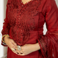 Red embroidered dress with intricate patterns worn by a person indoors.