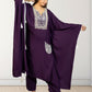 Woman wearing a purple traditional outfit with white embroidery against a white background