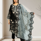 Woman holding a black and white embroidered dupatta in a neutral setting