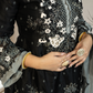 Black embroidered garment with floral patterns and gold accents