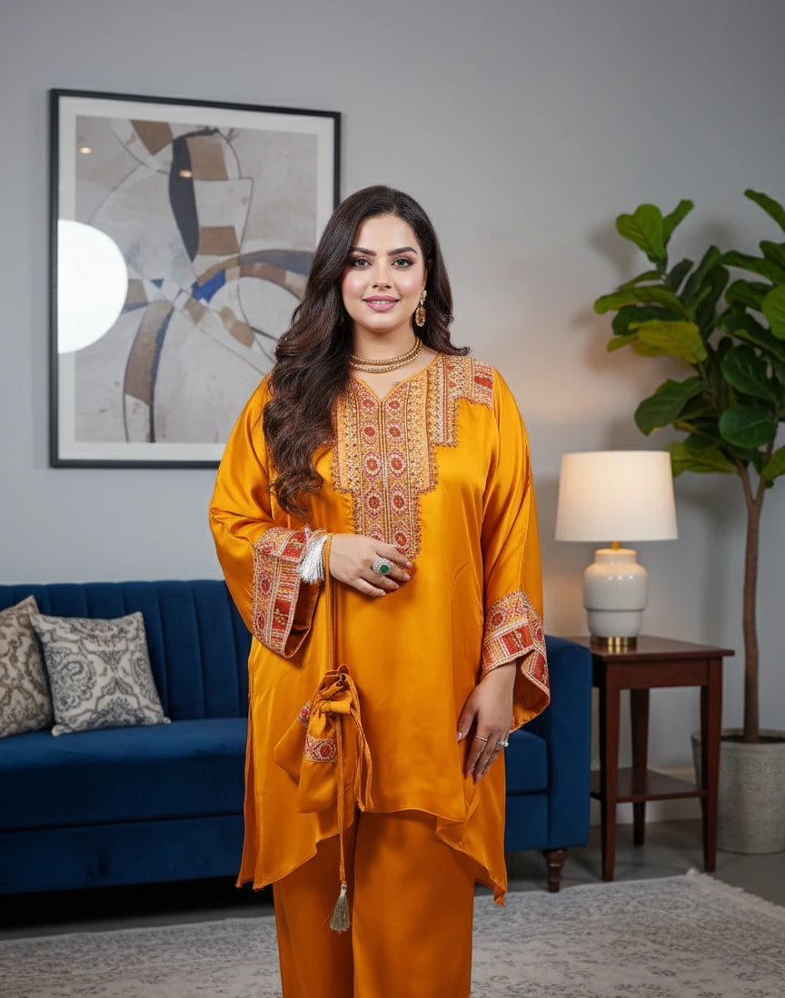 Woman in a mustard yellow traditional outfit standing in a living room.