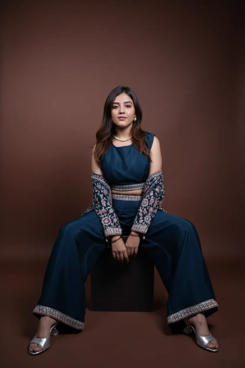 Woman in a blue traditional outfit sitting on a brown background