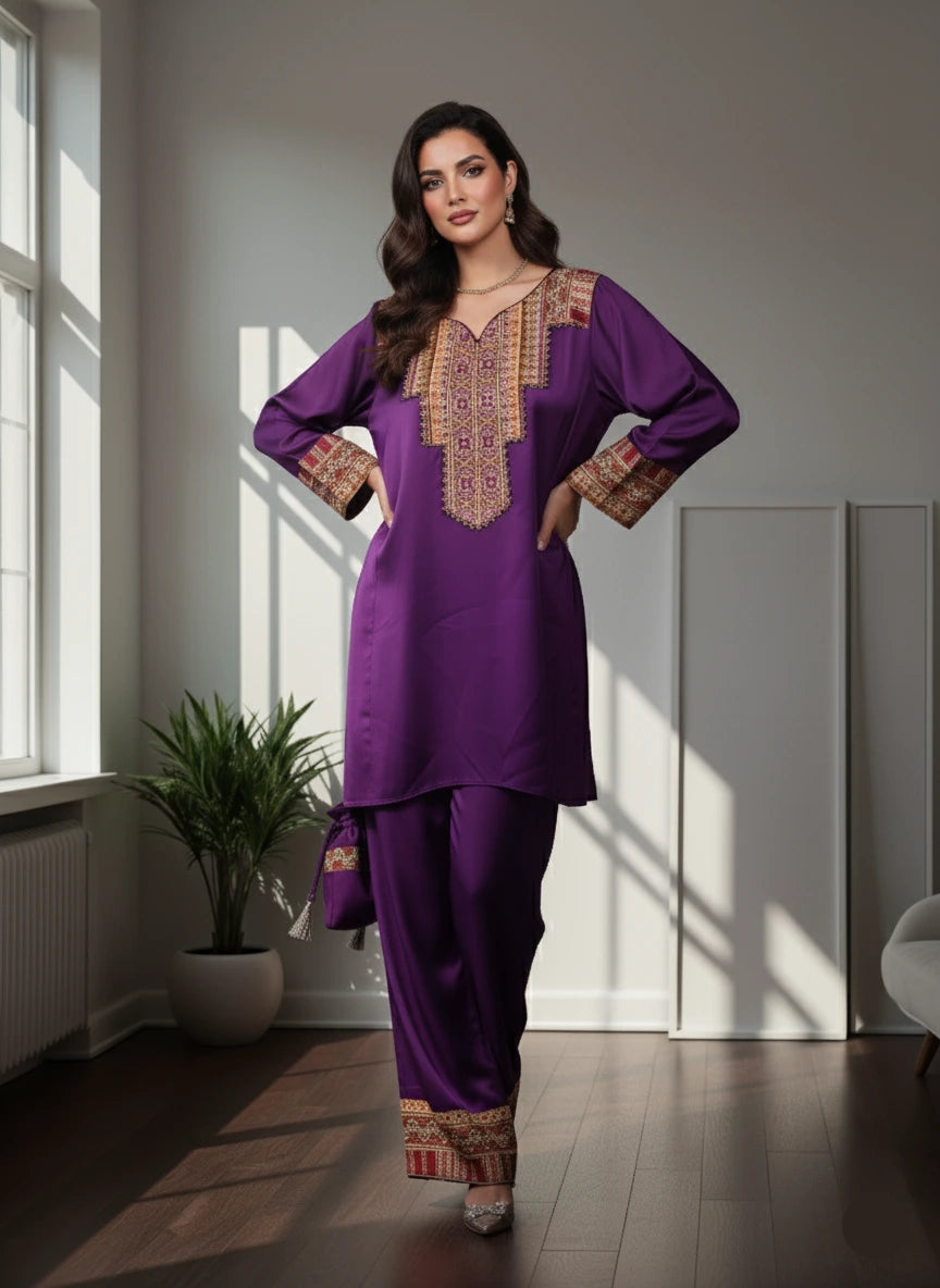 Woman wearing a purple traditional outfit with gold embroidery in a bright room.