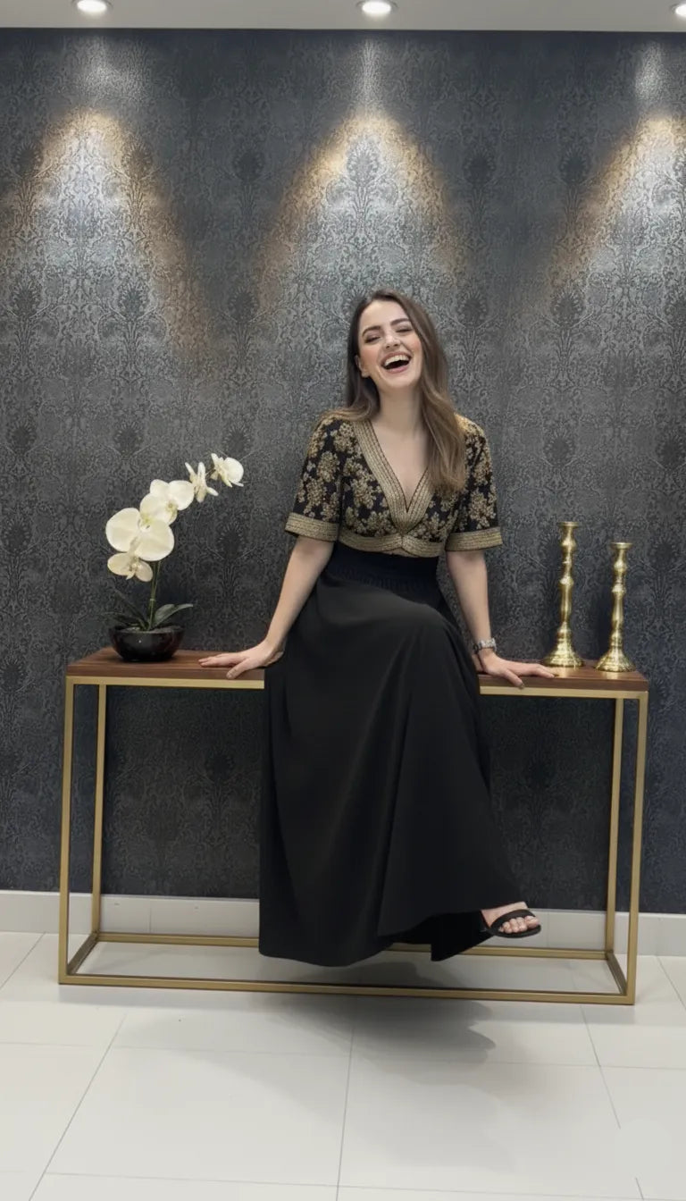 Woman sitting on a small table with a decorative background