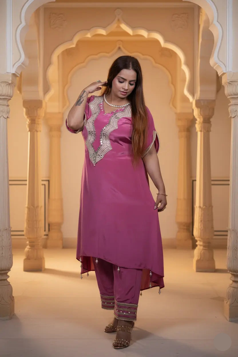 Woman in a pink traditional outfit standing in an ornate architectural setting