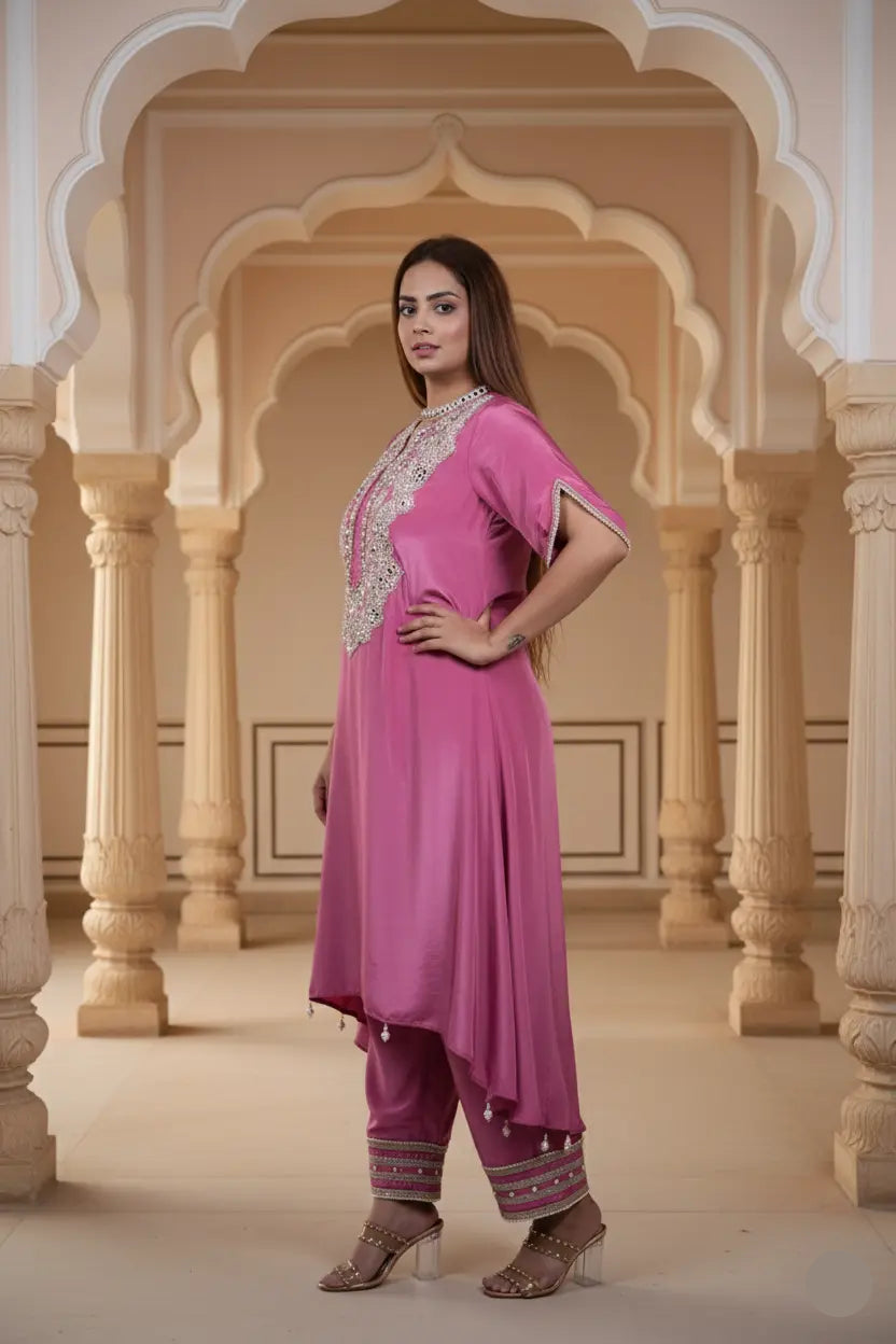 Woman in a pink traditional outfit standing in an ornate architectural setting