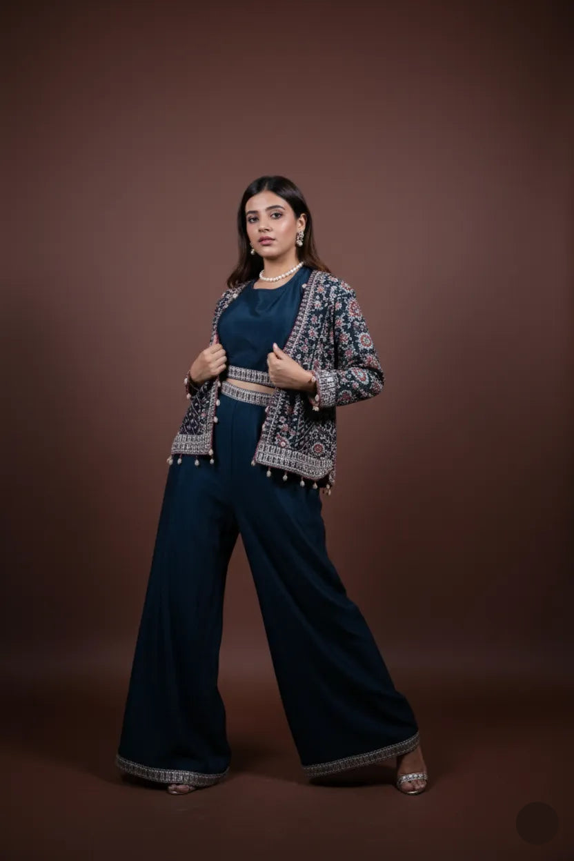Woman wearing a blue outfit with an embroidered jacket on a brown background