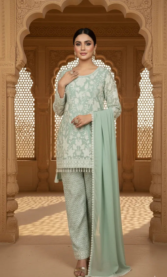 Woman in a light green traditional outfit standing in an architectural setting.
