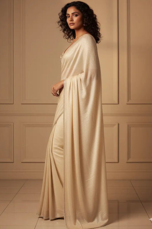 Woman wearing a beige evening gown against a beige paneled wall.