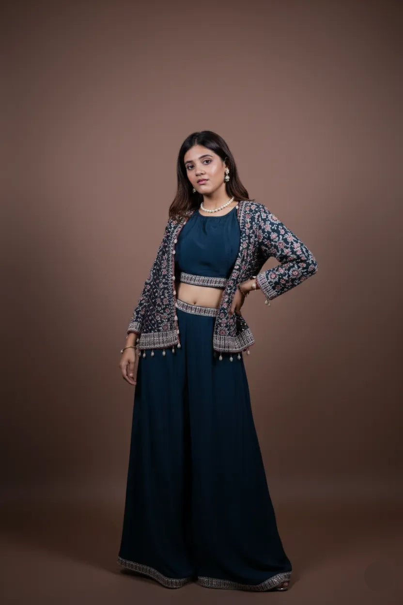 Woman wearing a traditional outfit with a dark blue top and pants against a brown background