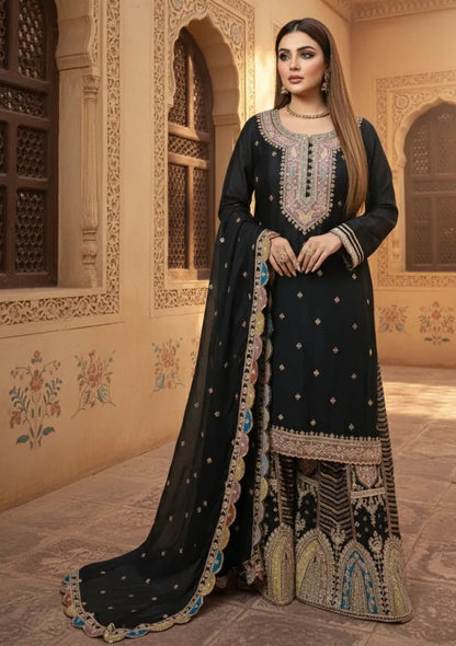 Woman in a black embroidered traditional outfit standing in an ornate room.