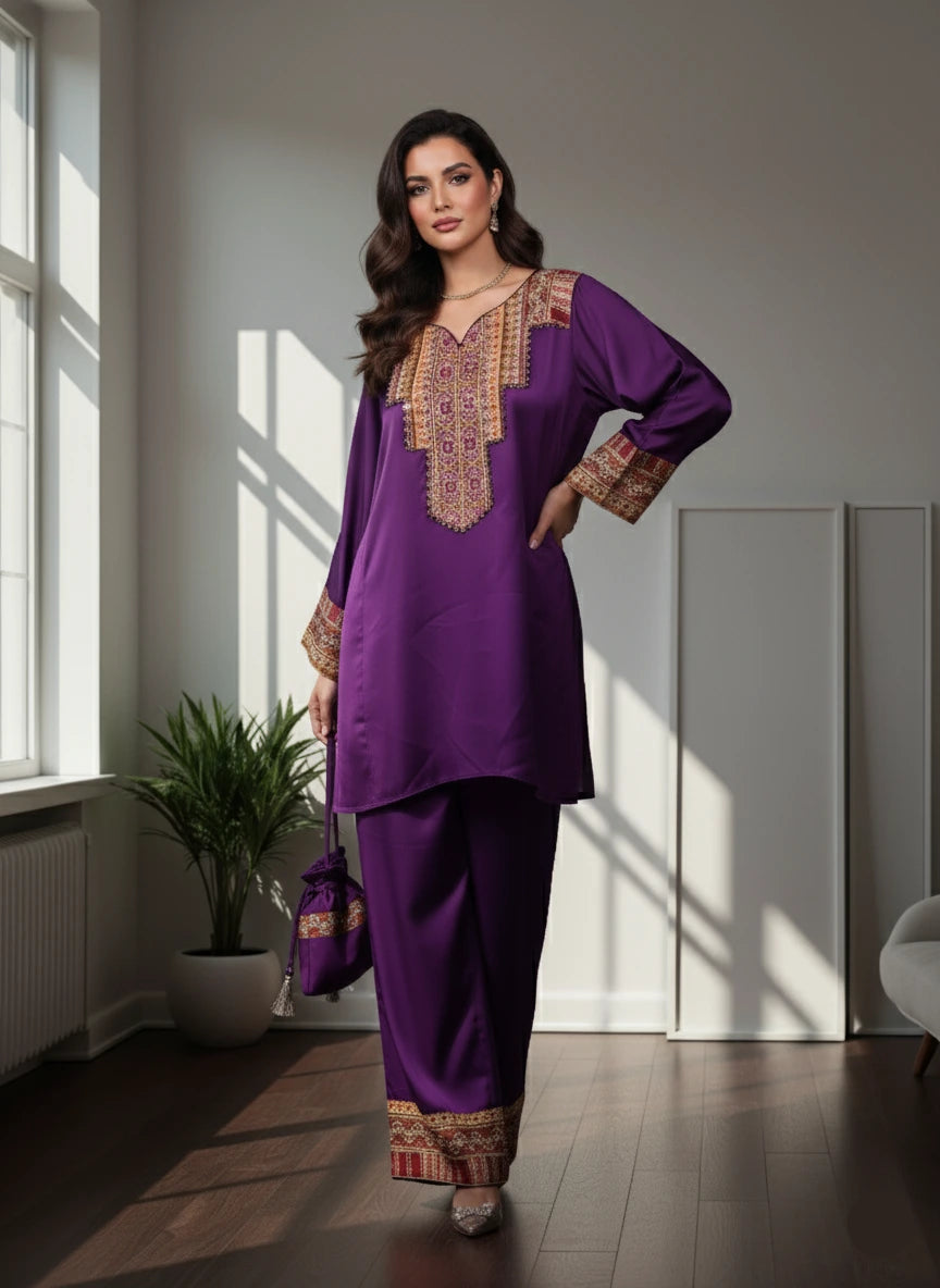 Woman wearing a purple traditional outfit with gold embroidery in a bright room.