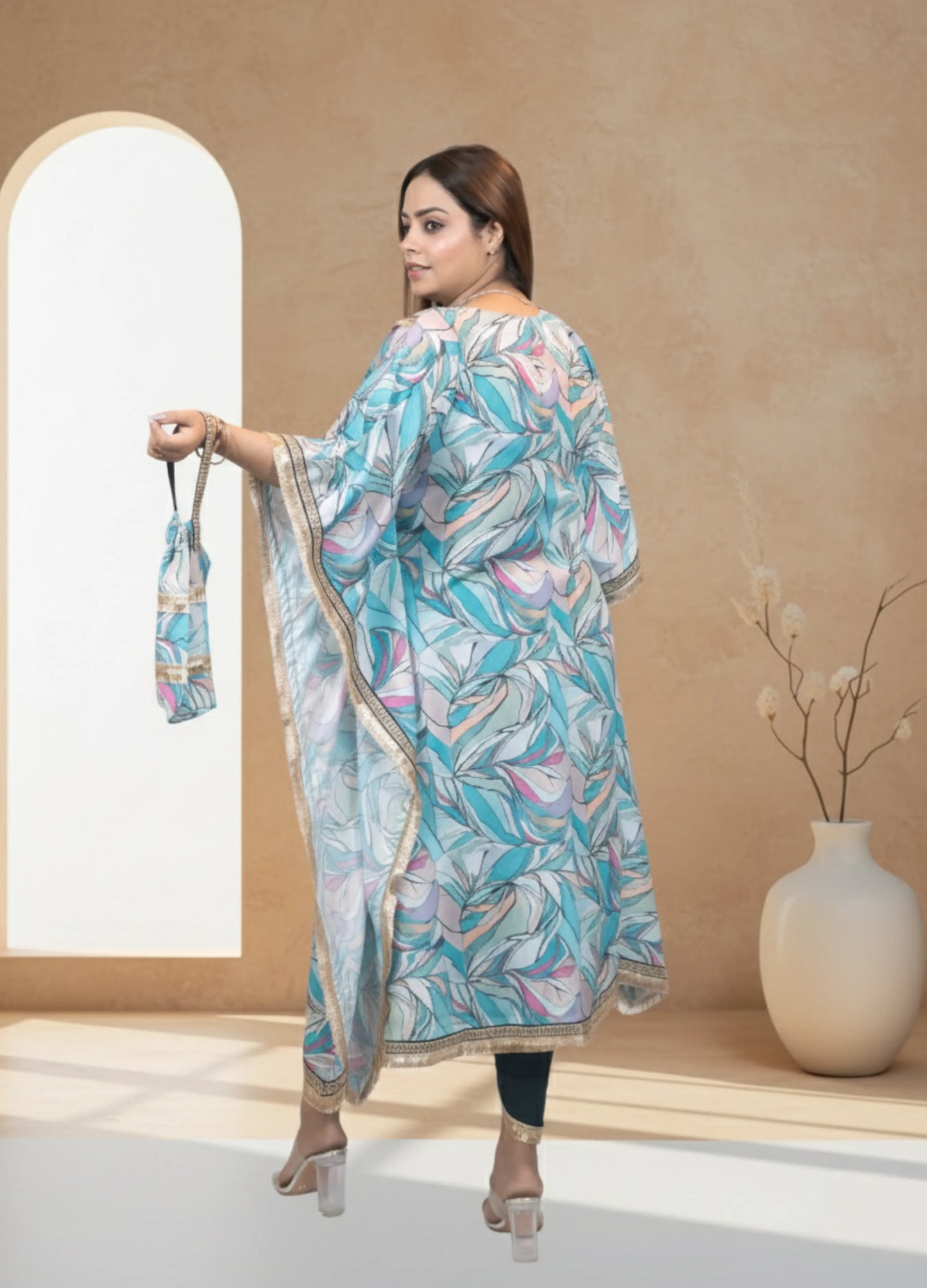 Woman in a floral dress holding a matching bag in a minimalistic setting