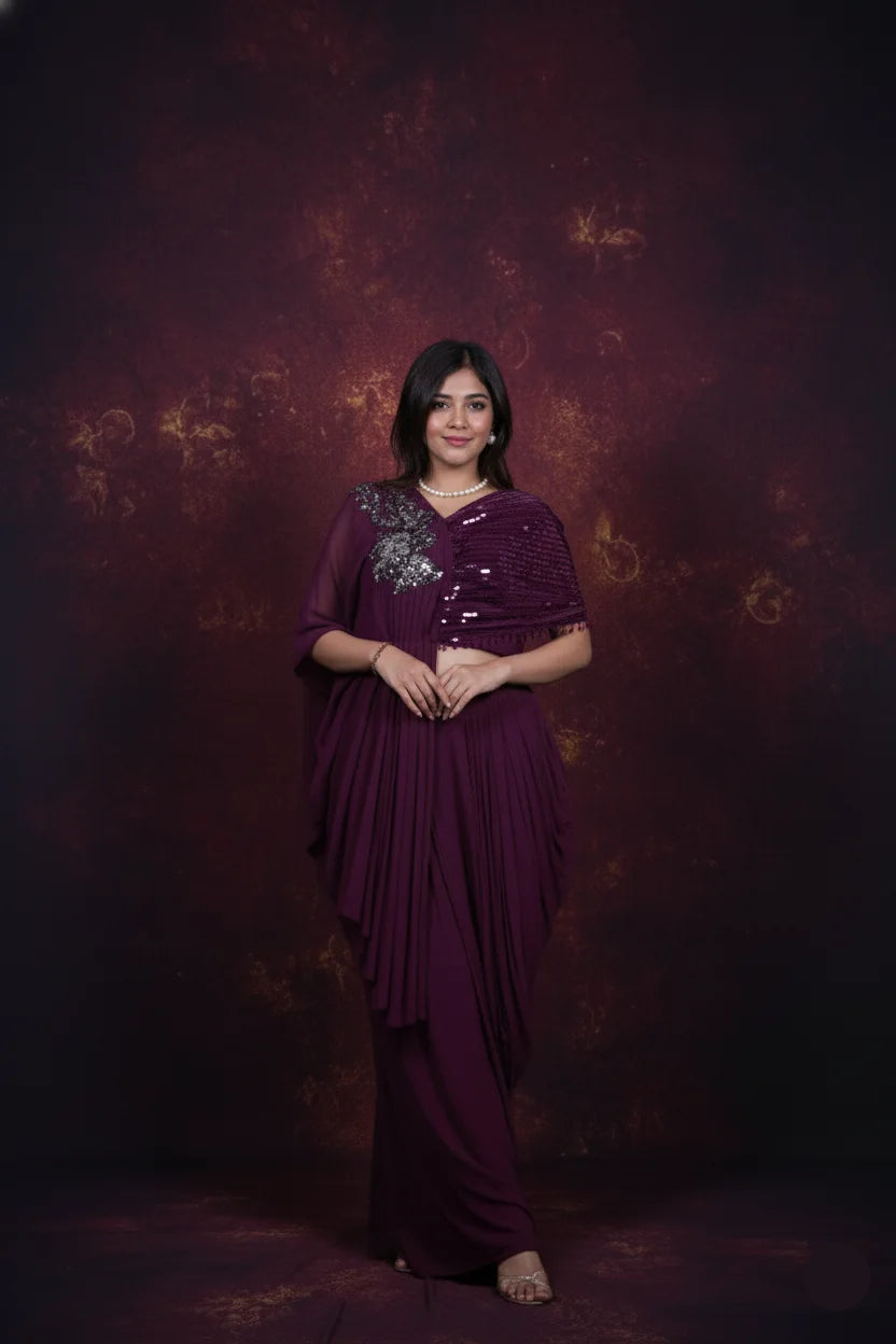 Woman in a purple saree with a textured dark background