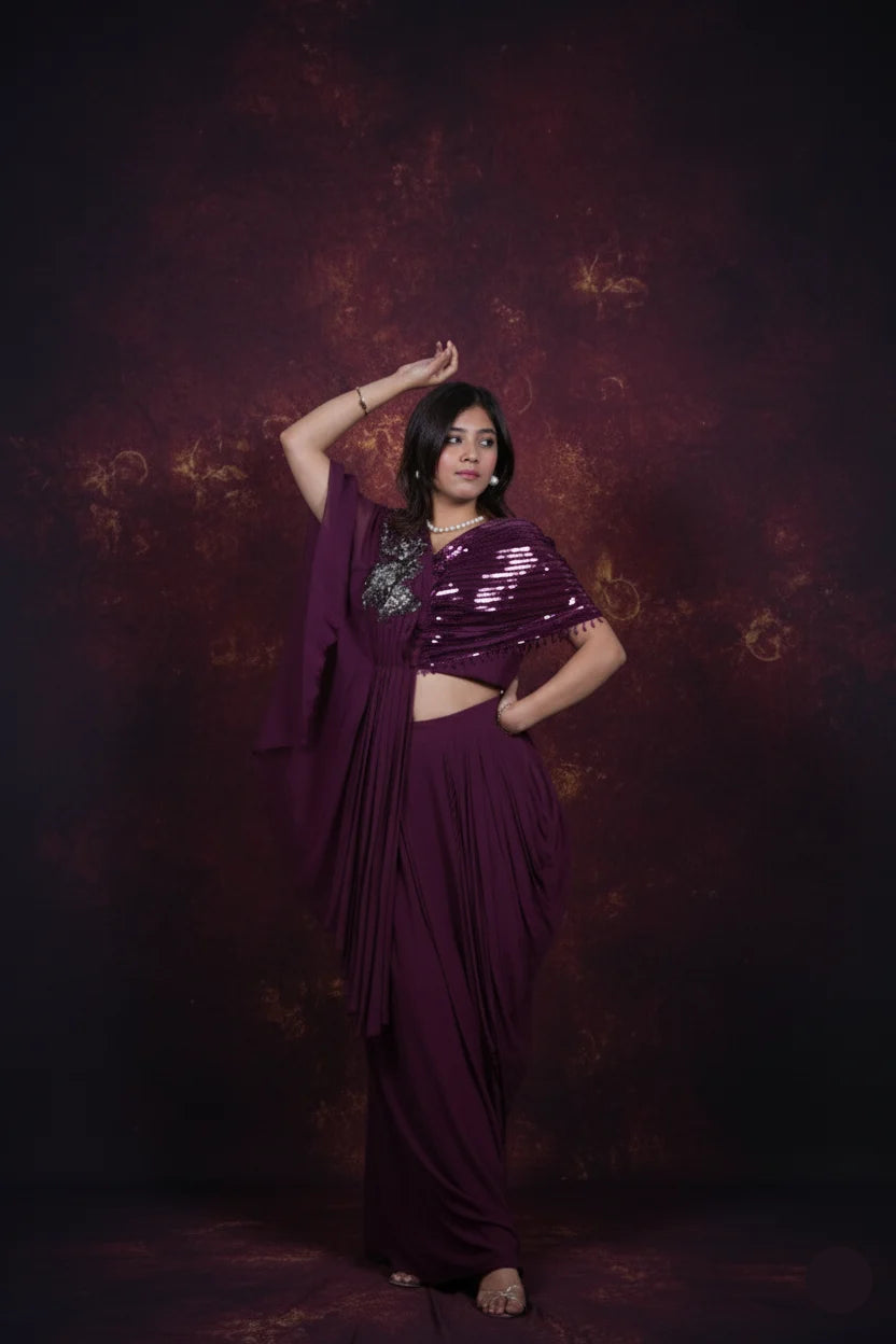 Woman in a purple saree with a textured dark background