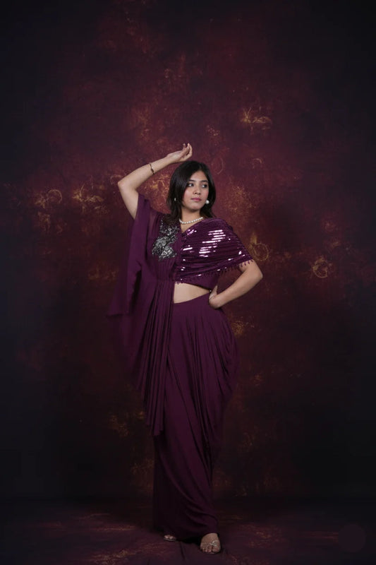 Woman in a purple saree with a textured dark background