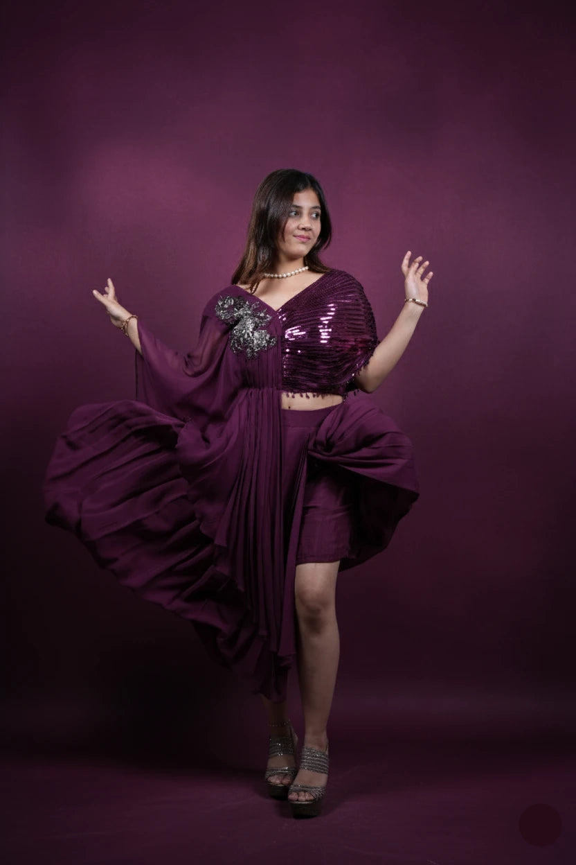 Woman in a purple outfit posing against a purple background