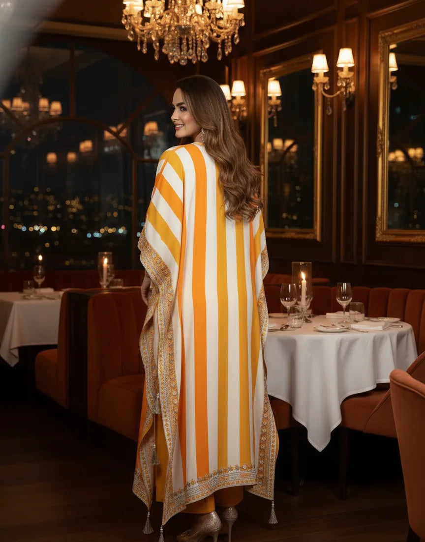 Woman in a long, striped dress walking through a restaurant with a cityscape view.