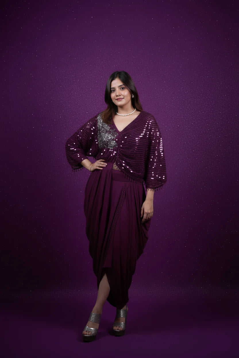 Woman wearing a purple dress with sequin embellishments against a purple background