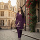 Woman in a purple outfit walking on a cobblestone street with floral decorations.