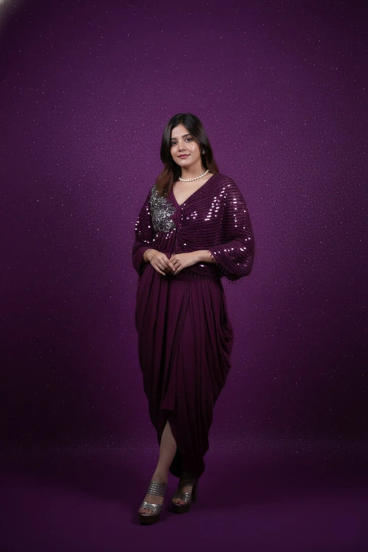 Woman wearing a purple dress with sequin details against a purple background