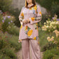 Woman in a floral outfit standing in a garden